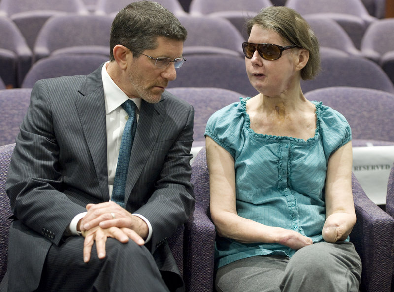 Charla Nash, right, talks with attorney Matthew D. Newman before a hearing in Hartford, Conn., on Friday. Nash, who was mauled in a 2009 chimpanzee attack, was attending the hearing to determine whether she may sue the state for $150 million in claimed damages.