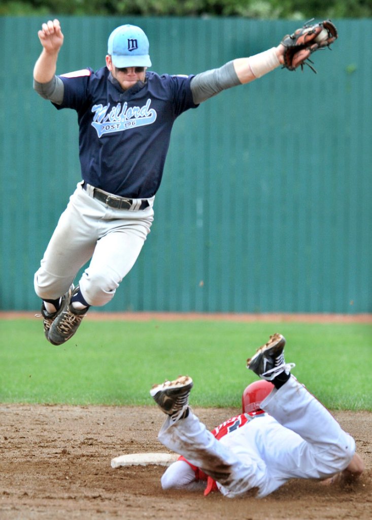 Alexander Pernick of Barnstable, Mass., slides into second with a stolen base Saturday as Christian Baglini of Milford, Conn., takes the throw. Milford won, then later beat First Title.