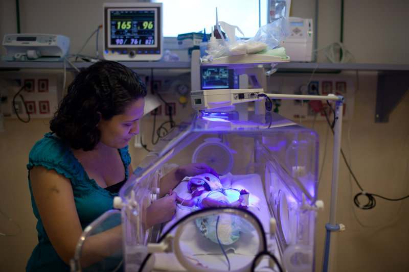 Mariana Migon caresses her premature daughter, Sofia, on July 25, at a public hospital in Rio de Janeiro. Migon abandoned her doctor, her health plan and her private hospital room to increase her chances of a vaginal birth.
