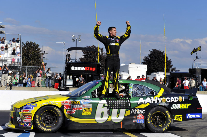 Carl Edwards stands atop his car after winning the Nationwide Series race at Watkins Glen, N.Y., on Saturday. Edwards, running his first Nationwide race this season, held off fellow Sprint Cup driver Brad Keselowski.