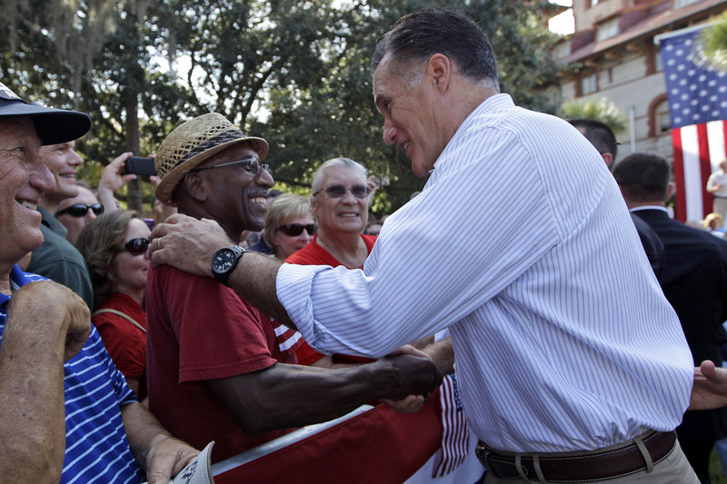 Mitt Romney greets Thomas and Patricia Evans during an event Monday at Flagler College in St. Augustine, Fla.
