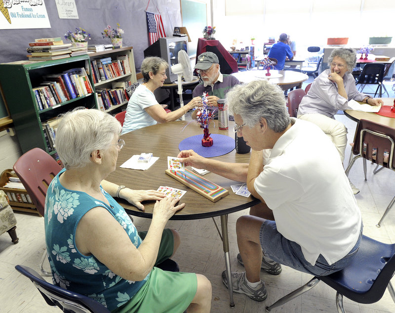 Ethel Blake and Rosemary Holleman, pictured here earlier this week, are among the seniors who enjoy playing cards and socializing at the Lakes Region Senior Center inside the Gorham Activity Center in Gorham. The group now has more than 100 members – and less than a year to find a new place to meet.