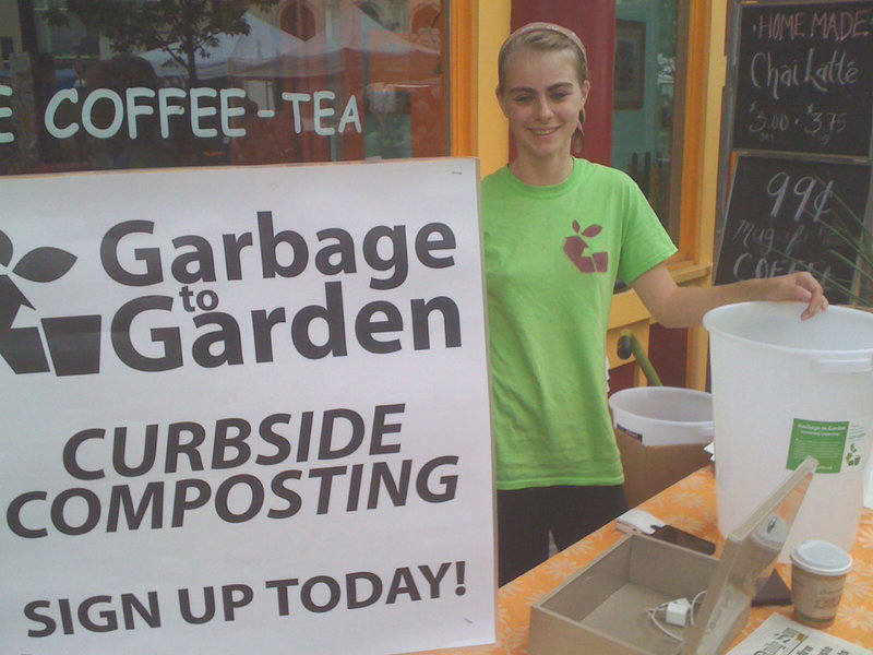 Sable Sanborn staffs the Garbage to Garden sign-up table at the Portland Farmers Market in Monument Square. She and her partner, Tyler Frank, offer curbside pickup of compost materials in Portland, South Portland and Falmouth.