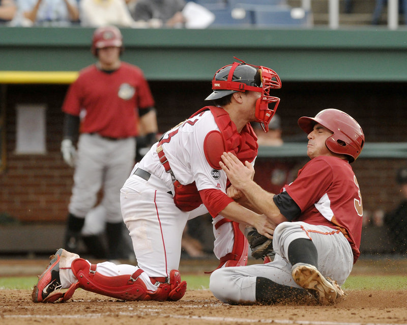Charlie Cutler of the Altoona Curve is cut down at the plate on a throw from left fielder Peter Hissey – a key moment Thursday night in a 2-1 victory for the Portland Sea Dogs. Applying the tag is catcher Christian Vazquez.