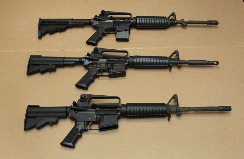 Three variations of the AR-15 assault rifle are displayed Wednesday at the California Department of Justice. Although the guns look similar, the bottom version is illegal in California because of its quick-reload capabilities.