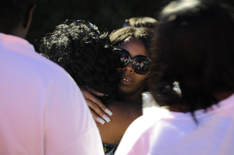 Teresa Carter, mother of Chavis Carter, is hugged by supporters after a candlelight vigil held Aug. 6 in her son’s honor in Jonesboro, Ark. Police video, released under the Freedom of Information Act, hasn’t resolved questions about whether he shot himself in the head as officers said.