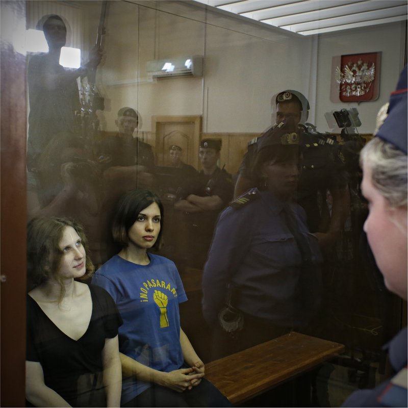 Maria Alekhina, left, and Nadezhda Tolokonnikova, two of the three members of the Russian feminist punk rock group Pussy Riot, sit in a glass cage in a Moscow courtroom Friday. The case ended Friday with three band members’ conviction for hooliganism and sentences of two years each in prison.
