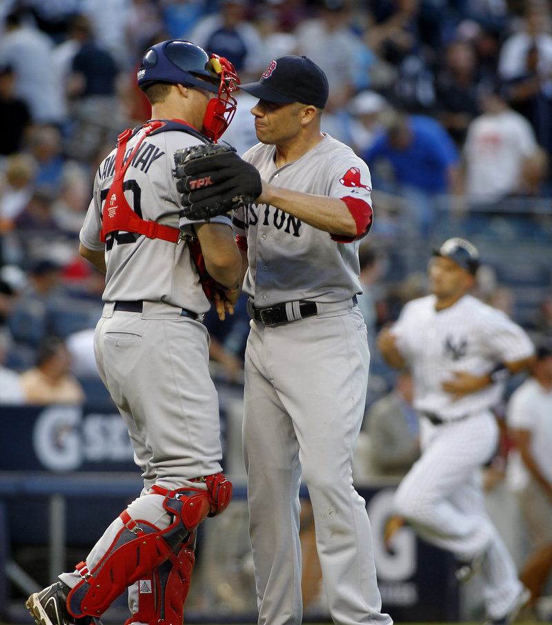 Alfredo Aceves, right, is congratulated by catcher Ryan Lavarnway after closing out a 4-1 win Saturday for the Red Sox over the Yankees.