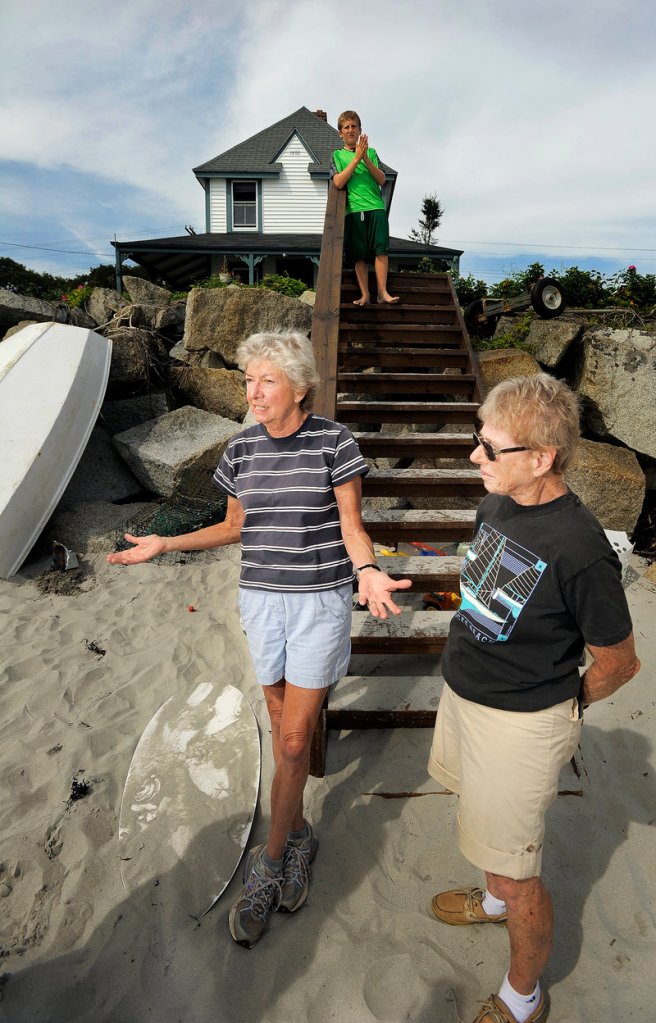 Ann Pick of Minnesota, left, and Barbara Young of Arizona stand in front of one of two houses their family owns on Goose Rocks Beach on Monday. Both Pick and Young said they believe the current right of access to the beach should stay unchanged.