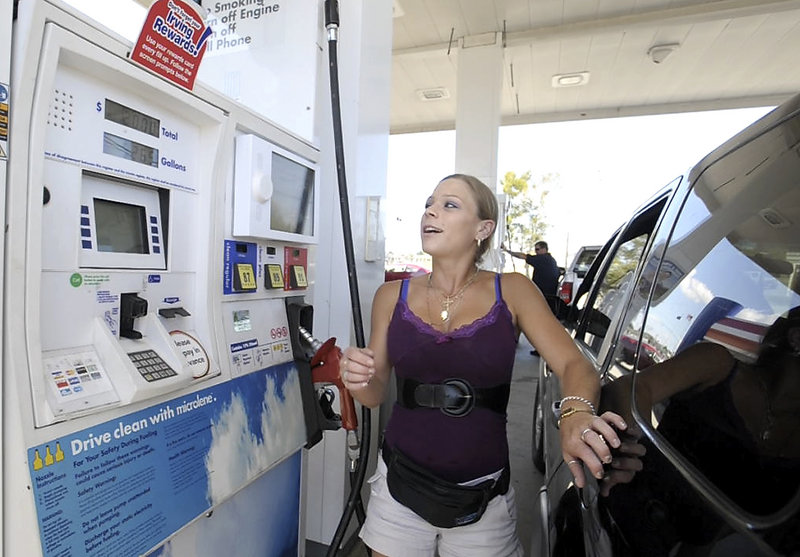 Andrea Colon of Scarborough gets some preseason football news from the pump video screen as she fills up at the Irving Station on Western Avenue on Tuesday.