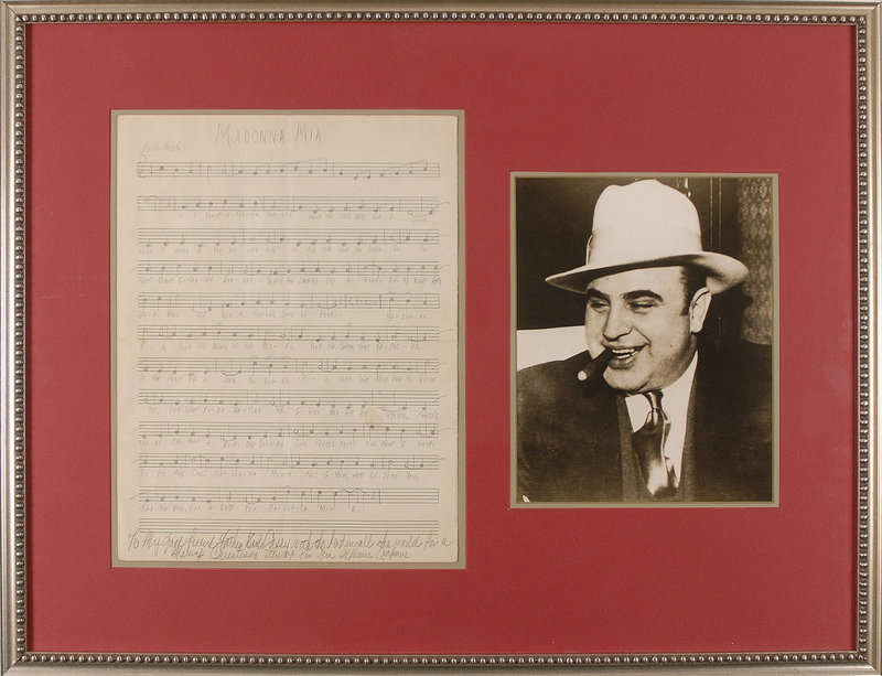 This photo from RR Auction in Amherst, N.H., shows a photograph of Al Capone and his hand-written score for “Madonna Mia,” a love song he wrote to his wife while he was in prison on Alcatraz. The items will be auctioned Sept. 30.