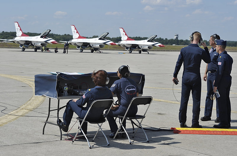 Members of the Air Force communication team help the pilots and support staff prepare Thursday for a trial run of the Great State of Maine Air Show at Brunswick Landing. Three of the eight Air Force Thunderbirds are lined up here and ready to go.