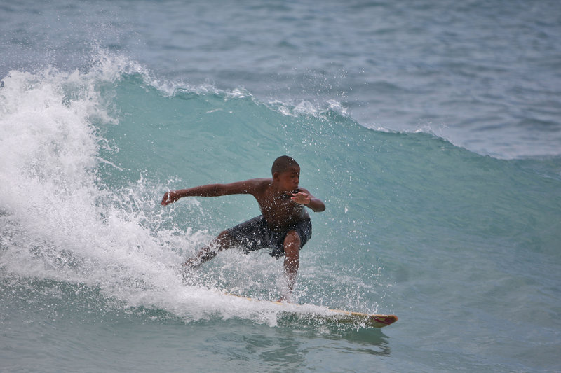A boy surfs a wave at a beach in Barahona, Dominican Republic, before the anticipated arrival of Tropical Storm Isaac on Thursday. U.S. forecasters said Isaac will likely turn into a Category 1 hurricane by Friday as it nears the Dominican Republic and Haiti.