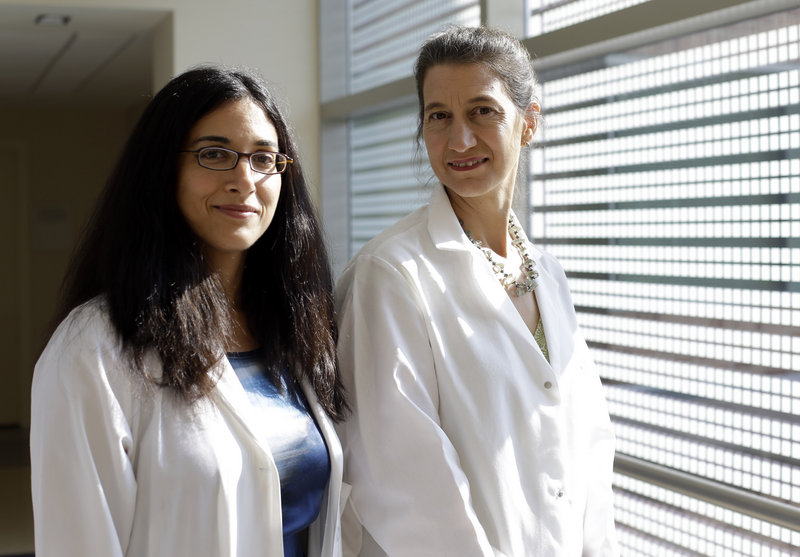 Dr. Tara Palmore, deputy hospital epidemiologist at the National Institutes of Health Clinical Center, left, and Dr. Julie Segre, a geneticist with the National Human Genome Research Institute, are shown at the NIH Clinical Center in Bethesda, Md., where a deadly superbug killed six patients.