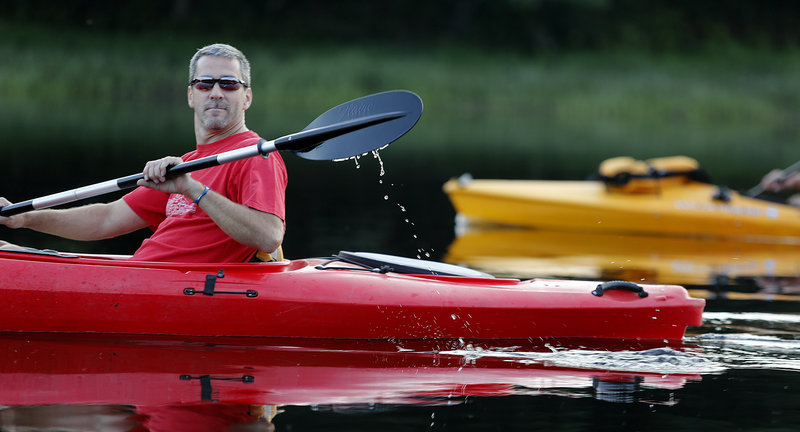 Kenny Jacques of Jay paddles his kayak along the Androscoggin River during the weekly Androscoggin Land Trust excursion. The river is now a prime spot to visit, which also should boost economic activity along its banks.