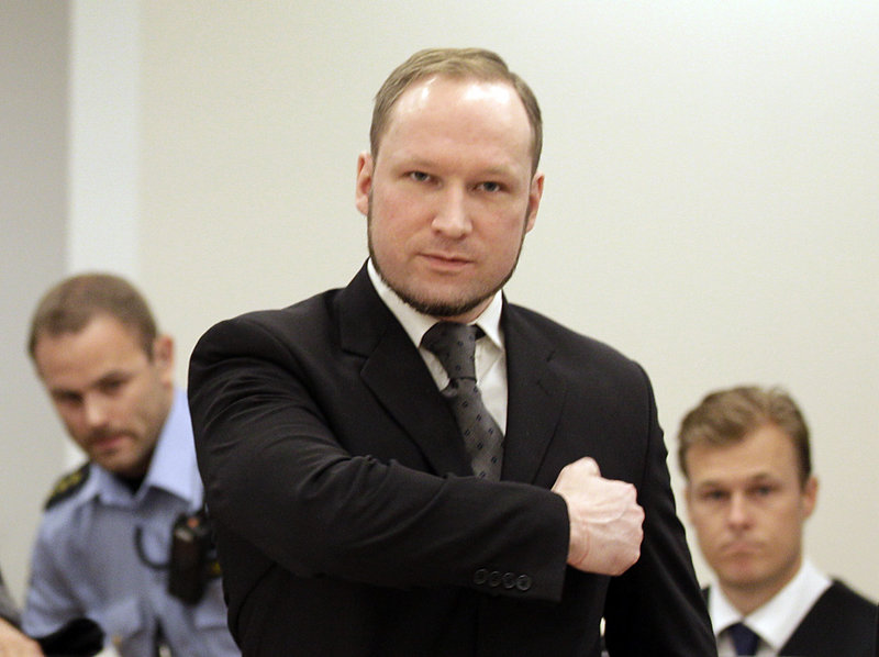 Norwegian Anders Behring Breivik gestures as he arrives Friday at the courtroom in Oslo, where he was sentenced to prison for twin attacks that killed 77 people last year.