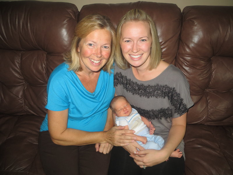 Madden Hebert rests with his mom, Angel Hebert, right, and his grandmother, Linda Sirois. Sirois carried the baby for her daughter, who has a heart condition.