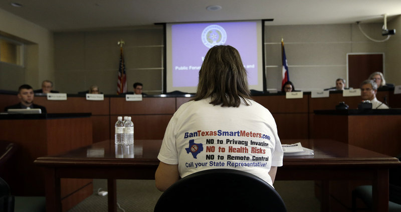 The Associated Press Members of the Texas Public Utility Commission listen to a speaker during a hearing last week in Austin examining the use of smart meters. Texas utilities have installed nearly 6 million smart meters, or 87 percent of their goal, but opposition is growing louder.