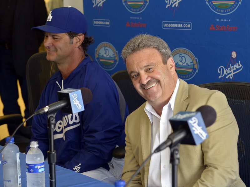 The Dodgers were all smiles after the trade Saturday, with General Manager Ned Colletti, right, and Manager Don Mattingly discussing what it meant to Los Angeles.