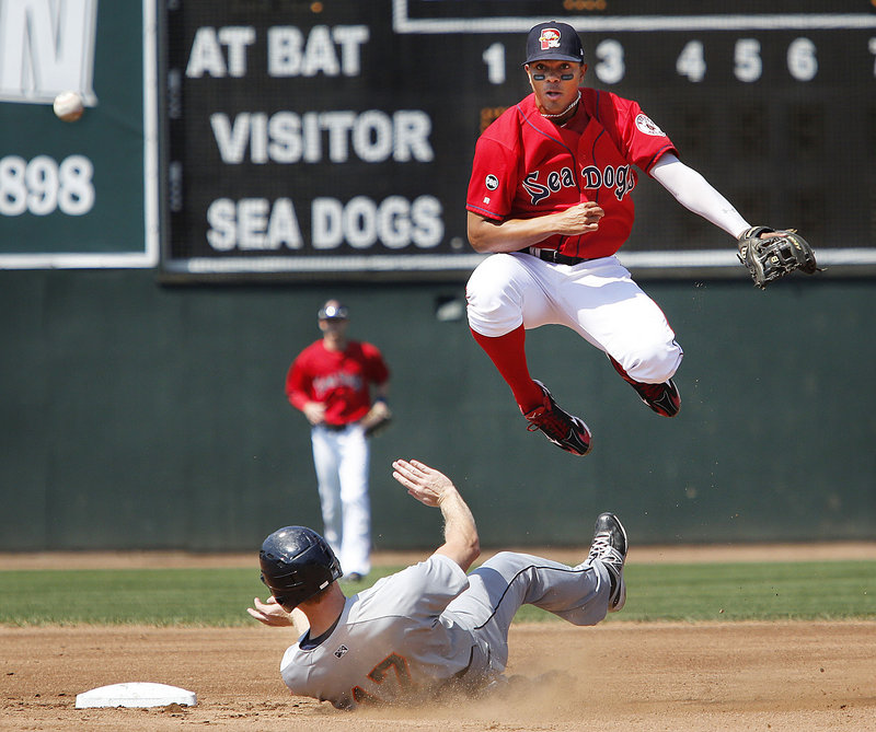 Sea Dogs shortstop Xander Bogaerts avoids Binghamton’s Dustin Martin while completing a double play Sunday. The Sea Dogs lost in 10 innings, 5-3, leaving them 5 1⁄2 games behind the Reading Phillies in the race for a playoff spot.