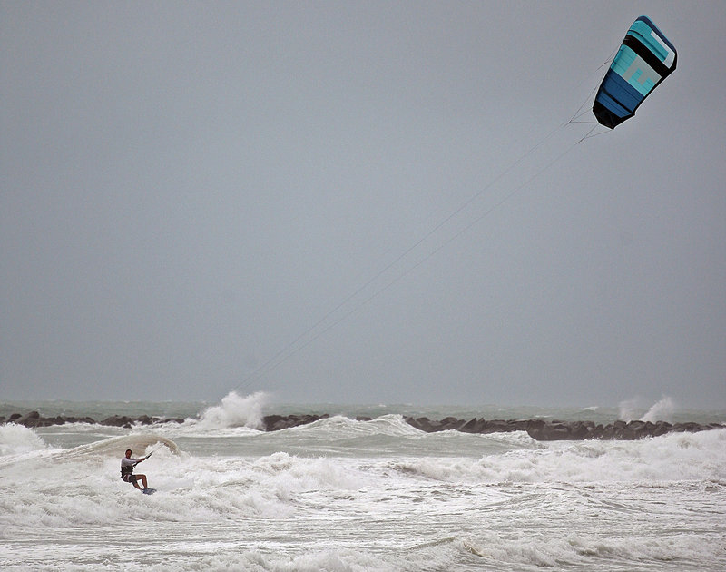 Folko Weltzien, 38, kite surfs as high winds from Tropical Storm Isaac gust Sunday in Miami. Forecasters say it could grow into a dangerous Category 2 hurricane.