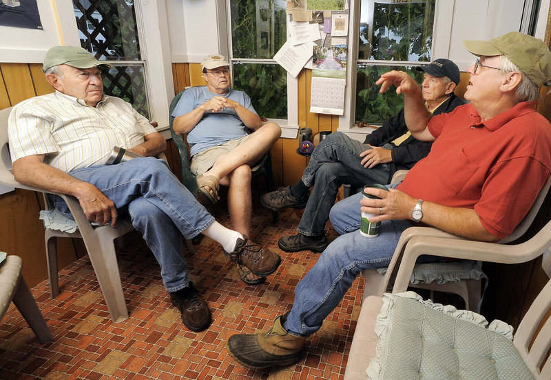 Wedgie Wheeler, right, makes a point as he discusses politics with his friends, from left, Chris Lutes, Alan Bradstreet and David Norman inside the cozy North Pownal Think Tank.