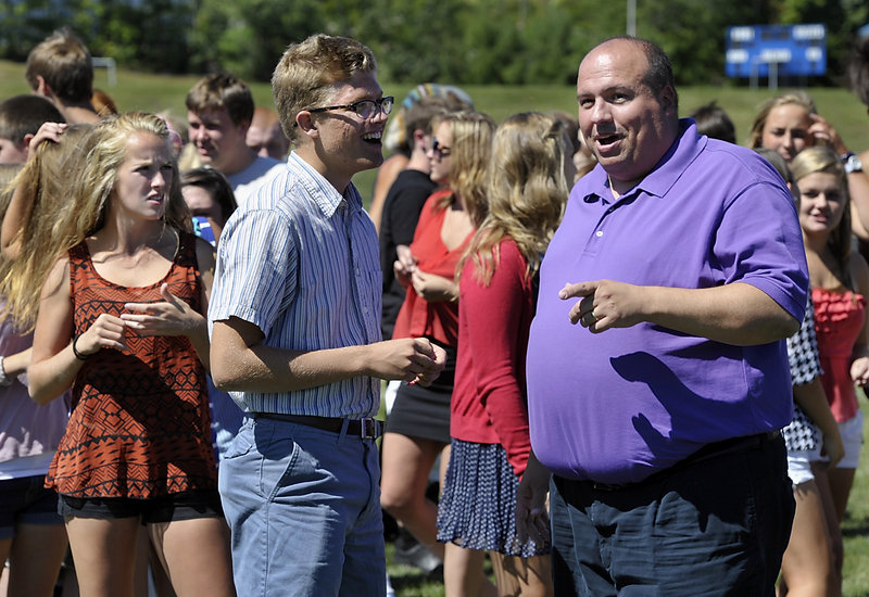 Lake Region High School Principal Ted Finn chats with student Class Publicist Mason Kluge-Edwards during a rally on the first day of school Wednesday. Students appear to be more engaged, Kluge-Edwards said.