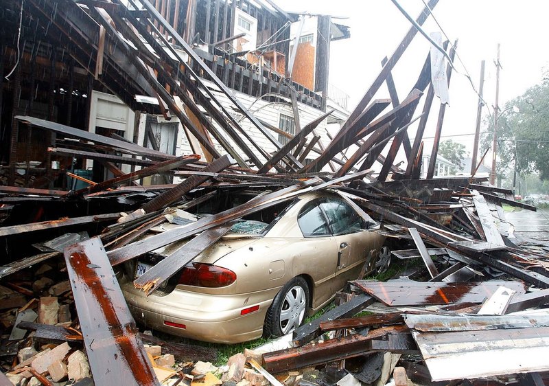 A house in New Orleans collapsed during the height of the storm, destroying three vehicles that were parked alongside.