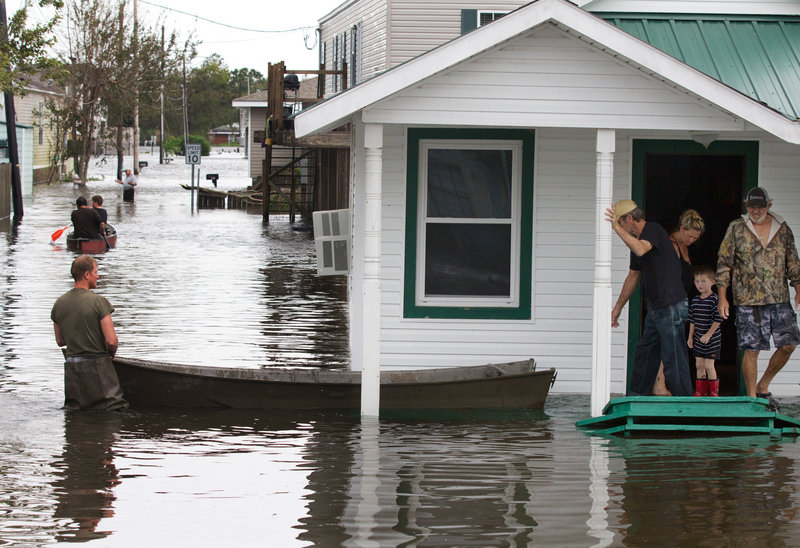 Flooding in Lafitte, La., causes residents to travel by boat Thursday, a day after Isaac hit the area near New Orleans.