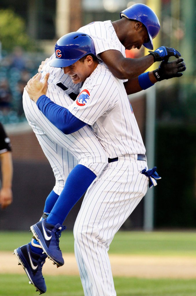 Alfonso Soriano of the Cubs, left, celebrates with Anthony Rizzo after Soriano singled home Starlin Castro in the bottom of the ninth to give Chicago a 12-11 win over the Milwaukee Brewers.