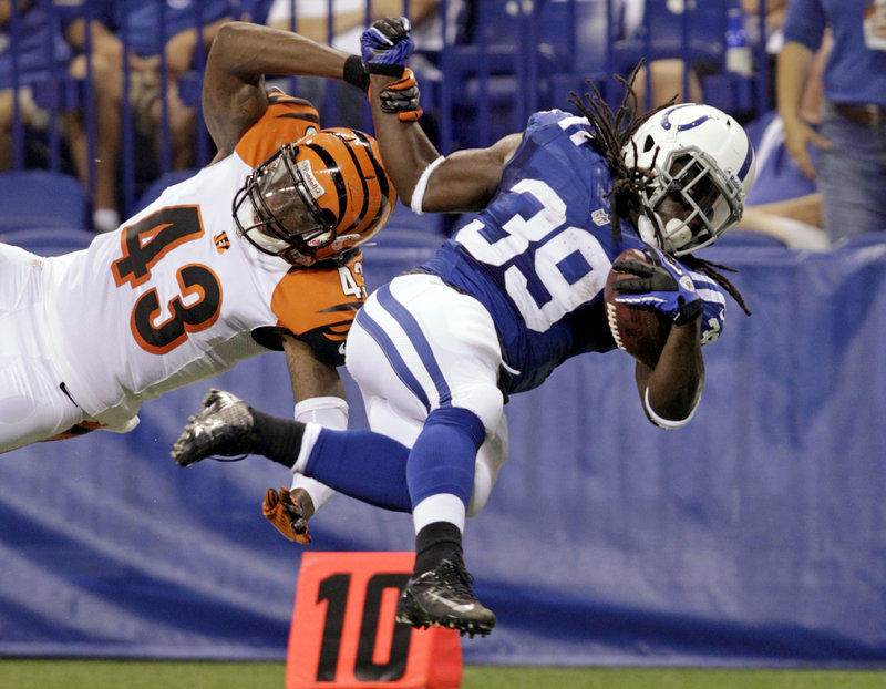 Deji Karim of the Indianapolis Colts, right, is brought down by safety George Iloka of the Cincinnati Bengals in the first half of Indianapolis’ 20-16 victory in an exhibition finale Thursday night at Indianapolis.