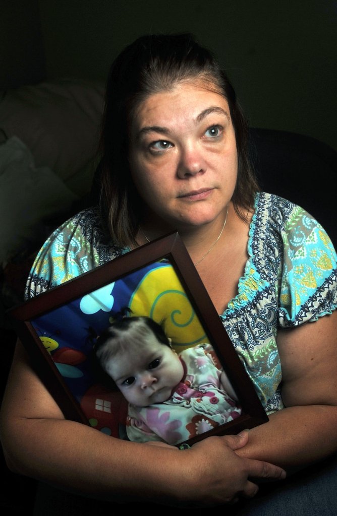 Nicole Greenaway holds a picture of her daughter Brooklyn Foss-Greenaway at her home in Clinton. Her 3-month-old baby died while in the care of Amanda Huard on July 8.