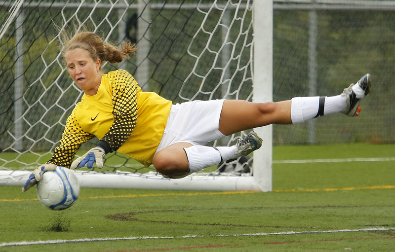 Falmouth goalie Caroline Lucas makes a diving stop – one of several key saves she made in the second half to help the Yachtsmen secure a 2-1 victory Friday in their season opener at Cape Elizabeth.