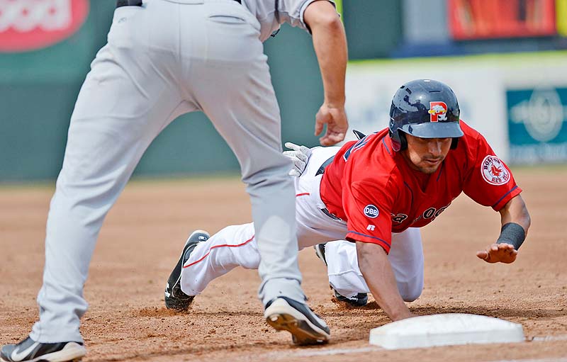Portland's Ryan Dent dives back to first base, avoiding a pickoff against the New Britain Rock Cats Sunday at Hadlock Field.