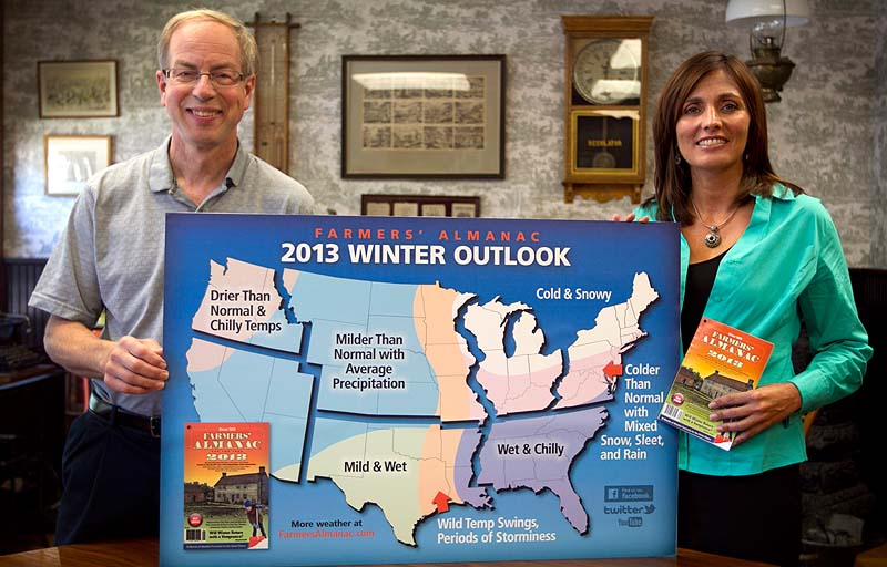 Farmers' Almanac publisher Peter Geiger, left, and editor Sondra Duncan pose in Lewiston last week with a map showing the predicted weather forecast for the United States. In an election year, the almanac dubs its forecast "a nation divided" because there's a dividing line where winter returns for much of the east, with milder weather west of the Great Lakes.