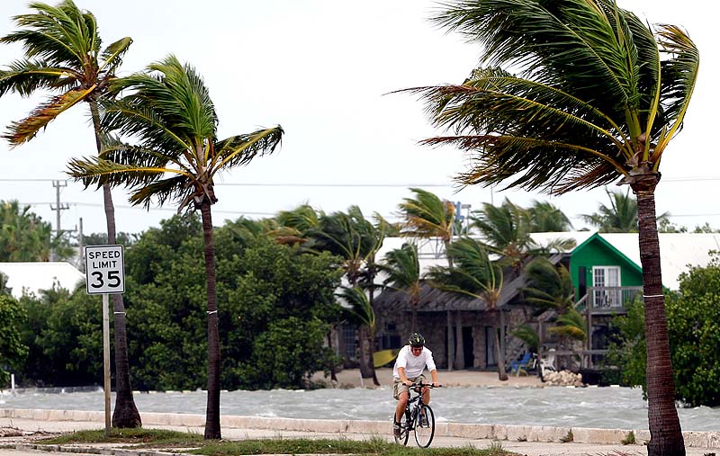 A cyclist rides his bike in Key West, Fla., on Sunday. Tropical Storm Isaac gained fresh muscle Sunday as it bore down on the Florida Keys, with forecasters warning it could grow into a dangerous Category 2 hurricane as it nears the northern Gulf Coast.