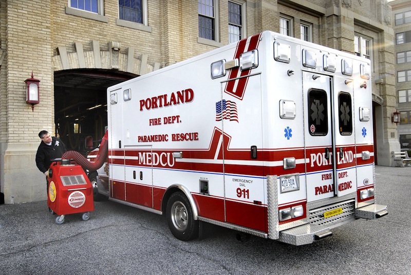 In this November 2009 file photo, Tim Nangle, a paramedic fireman with the Portland Fire Department, operates a machine outside the city's central fire station that helps disinfect emergency vehicles. The fire department has come under scrutiny over its overtime spending, which last year exceeded $2 million, by far the most of any city department.