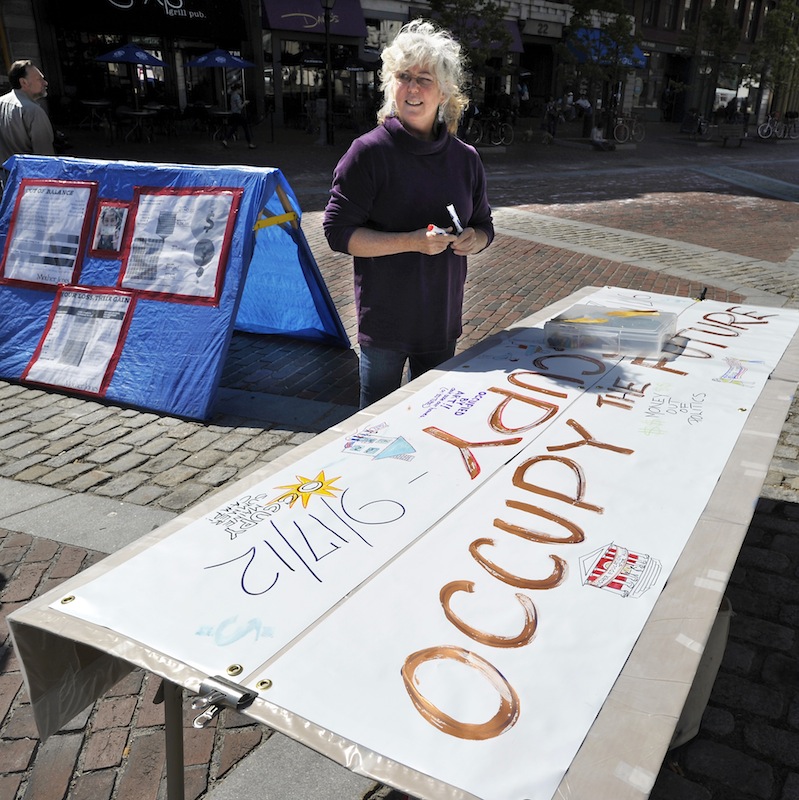 Nora Tryon of Kennebunkport discusses her roll in the girst anniversary of Occupy movement as she sets up in Monument Square on Monday, Sept. 17, 2012.