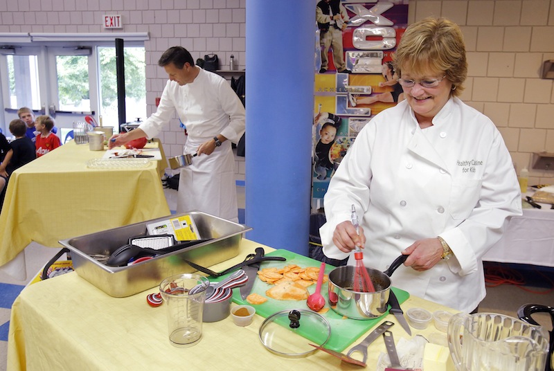 Ellen Demmons, right, food services director for RSU 21 and Jonathan Cartwright, executive chef at the White Barn Inn, compete in an Iron Chef-type competition at Sea Road School in Kennebunk on Friday, September 28, 2012. The secret ingredient announced at the start of the competition was sweet potatoes and the school's fourth graders from the school were the judges of the chefs' final creations.