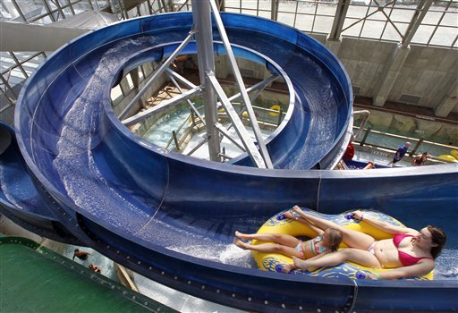 In this Aug. 8, 2012 photo, visitors ride on the La Chute at the Jay Peak Pump House indoor waterpark in Jay, Vt. Guests at Northern New England ski resorts are still enjoying waterparks and zip lines, but after a dismal, snowless winter, owners are looking ahead and trying to lock in skiers to season passes for the coming season. (AP Photo/Toby Talbot)