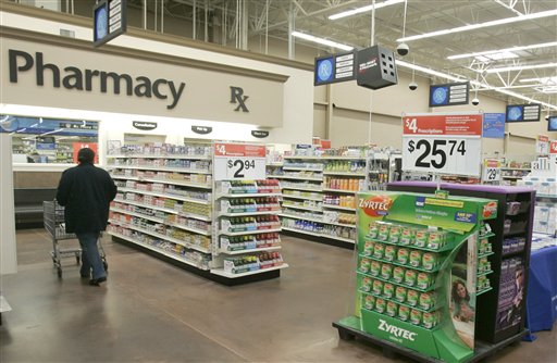 FILE - In this Feb. 20, 2008, file photo, a shopper walks toward the pharmacy at a Little Rock, Ark., Wal-Mart store. A study says seniors in seven of the 10 most popular Medicare prescription drug plans will be hit with double-digit premium hikes next year if they don�t shop for a better deal. The report by Avalere Health is a reality check against the Obama�s administration�s upbeat pronouncements. Back in August 2012, officials had announced that the average premium for basic prescription drug coverage would stay the same in 2013, at $30 a month. (AP Photo/Danny Johnston, File)