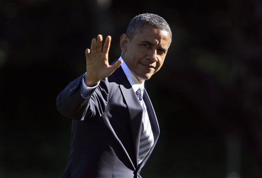 President Barack Obama waves as he walks across the South Lawn of the White House in Washington, during his return on Marine One helicopter, Tuesday, Sept. 11, 2012. Obama traveled to Walter Reed National Military Medical Center and visited with veterans who are being treated at the hospital and their families. (AP Photo/Pablo Martinez Monsivais)