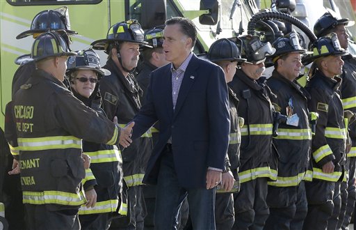 Republican presidential candidate Mitt Romney greets firefighters at Chicago O'Hare International Airport, Tuesday, Sept. 11, 2012. (AP Photo/Charles Dharapak)