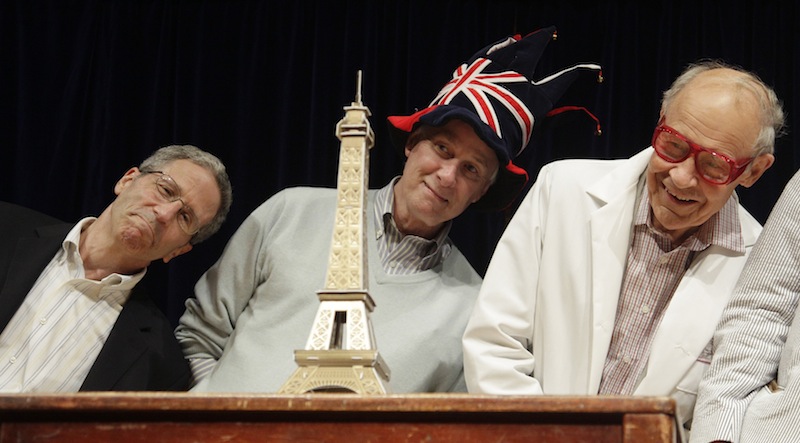 Nobel Prize laureates Eric Maskin, Rich Roberts and Dudley Herschbach lean over behind a mini Eiffel Tower during a performance at the Ig Nobel Prize ceremony at Harvard University, in Cambridge, Mass., Thursday, Sept. 20, 2012. The Ig Nobel prize is an award handed out by the Annals of Improbable Research magazine for silly sounding scientific discoveries that often have surprisingly practical applications. (AP Photo/Charles Krupa)