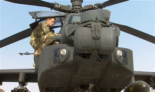 In this image from video, Britain's Prince Harry inspects an Apache helicopter at Camp Bastion in Afghanistan on Friday. Prince Harry will be based at Camp Bastion during his tour of duty as a co-pilot gunner.
