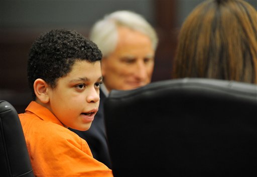 Cristian Fernandez, 13, left, talks with his attorneys in Judge Mallory Cooper's courtroom in Jacksonville, Fla., on Aug. 7. The case of Fernandez, who is charged with murdering his 2-year-old half brother and sexually abusing another young half sibling, is scheduled to be heard before Cooper on Sept. 28.