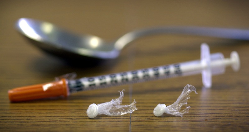 In this December 2002 file photo, packets of heroin, a syringe and a spoon are displayed at the Drug Enforcement Agency in Portland, Maine. Substance-abuse specialists in Maine say they're seeing a sharp increase in heroin addiction, even as progress is being made against the misuse of oxycodone and other prescription opiate painkillers. (AP Photo/Robert F. Bukaty) Drugs