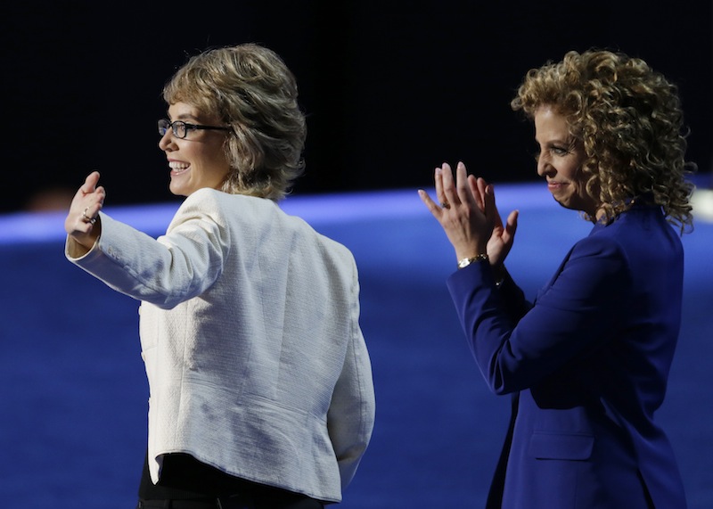 Former Rep. Gabrielle Giffords, left, walks with Democratic National Committee Chairwoman Rep. Debbie Wasserman Schultz, from Florida, to recite the Pledge of Allegiance the Democratic National Convention in Charlotte, N.C., on Thursday, Sept. 6, 2012. (AP Photo/Lynne Sladky)