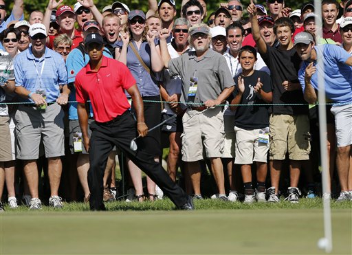 Tiger Woods reacts after his chip onto the green failed to drop into the hole during the final round of the Deutsche Bank Championship PGA golf tournament in Norton, Mass., on Monday.