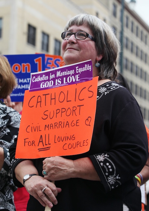 Kathy Tosney holds a sign as she listens to speakers Monday, Sept. 10, 2012 at a rally outside of City Hall in Portland, Maine, in support of a ballot question that seeks to legalize same-sex marriage. (AP Photo/Joel Page)